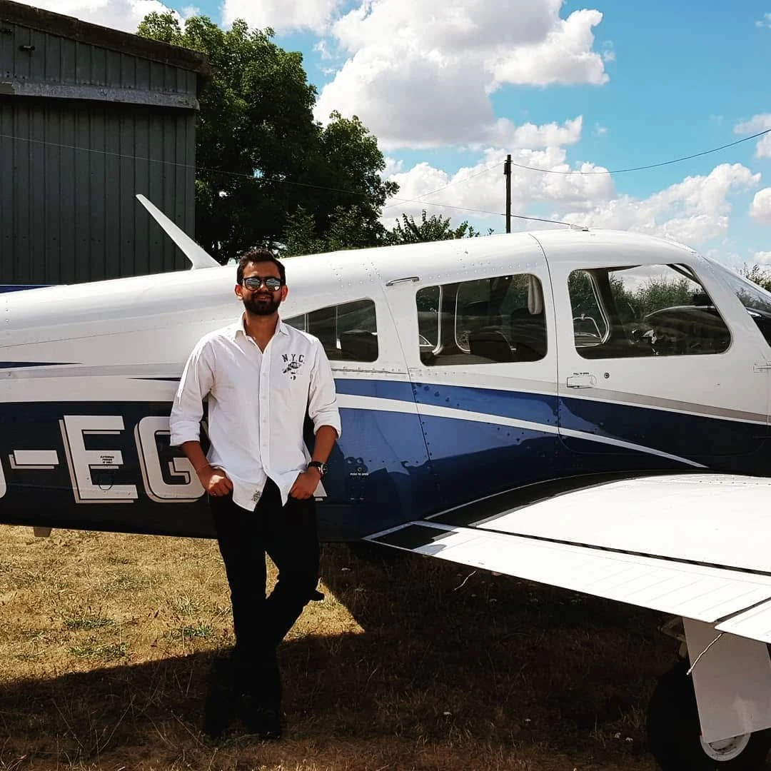 Vinamra beside an aircraft